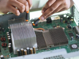 A technician is working on the electrical circuit with tester in hands.